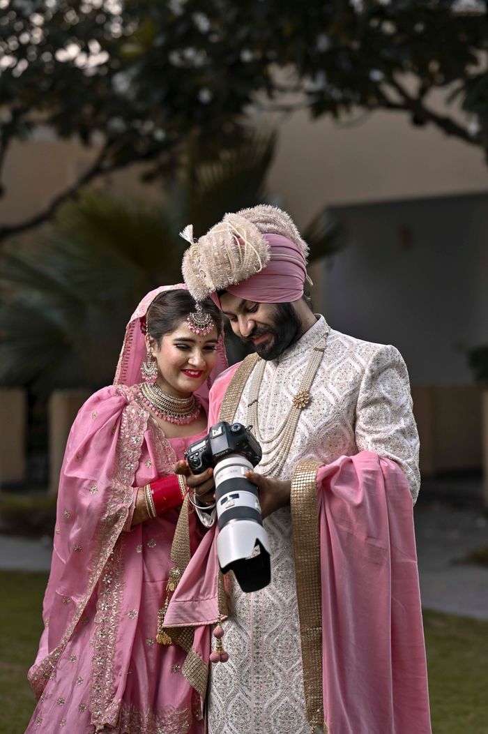 our-experience A joyful Indian bride and groom in traditional attire enjoy a moment during their wedding in Patiala, India.