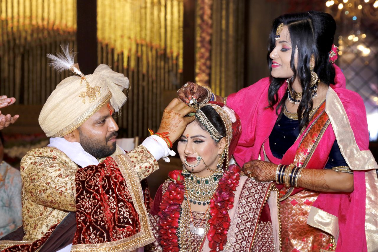 Bride and groom in a vibrant Indian wedding with cultural attire and customs.
