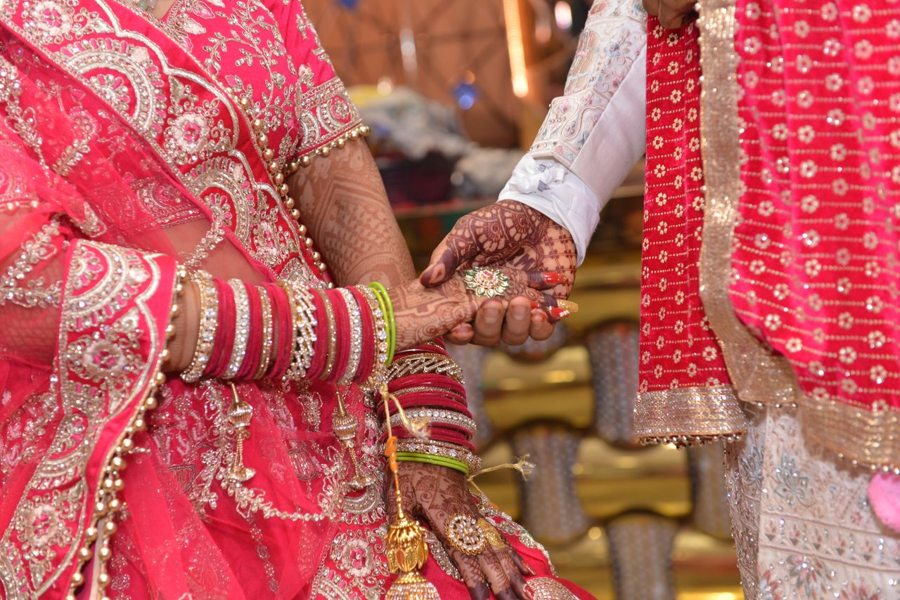 why-choose-us Close-up of a colorful Indian wedding ceremony featuring intricate henna designs and traditional attire.